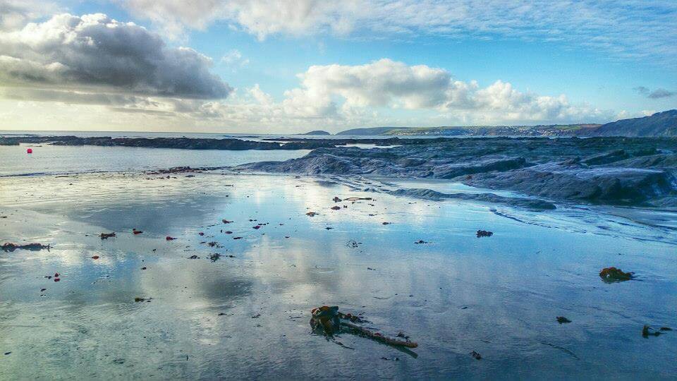 sky reflected in wet sand, seaton beach Cornwall