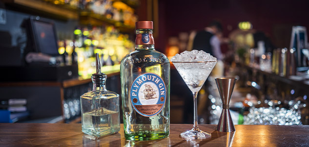 A Bottle of Plymouth Gin and glasses on the bar